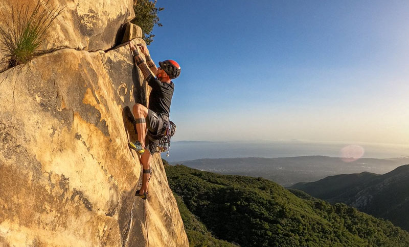 santa-barbara-rock-climbing-course-3b Rock climber, Alex Bury scales a sheer sandstone cliff, overlooking the ocean in Santa Barbara.