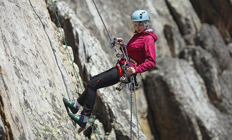 Santa Barbara County rock climber rappelling down a steep rock face in Ventura, California