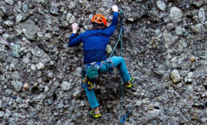 Santa Barbara rock climber learning to scale a wall outside of Ojai, California.