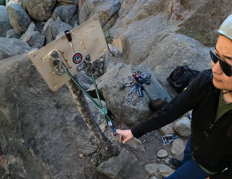 A guest learns to build rock climbing anchors in Santa Barbara.