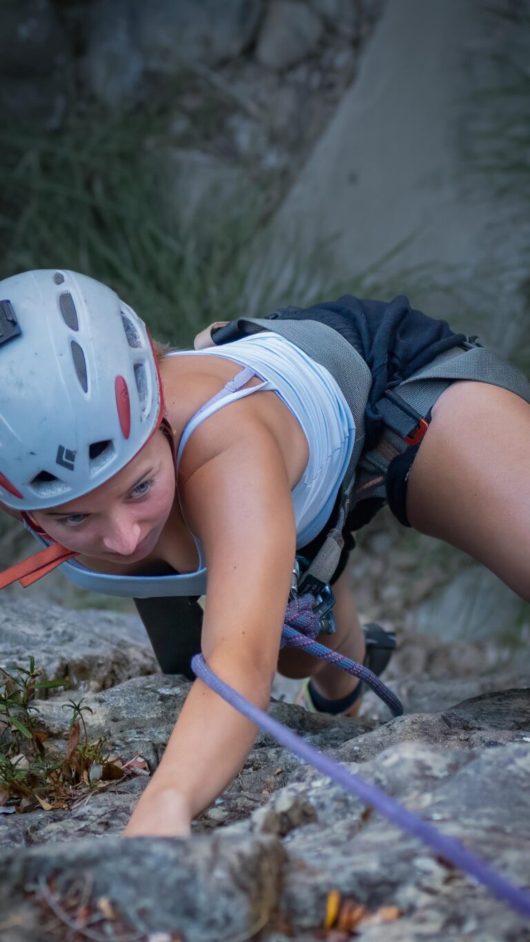 Woman climbing a sandstone route in Santa Barbara during a guided top-rope session.