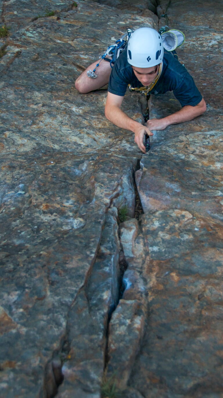 Climber progressing up a multi-pitch crack system during guided rock climbing instruction in Santa Barbara.